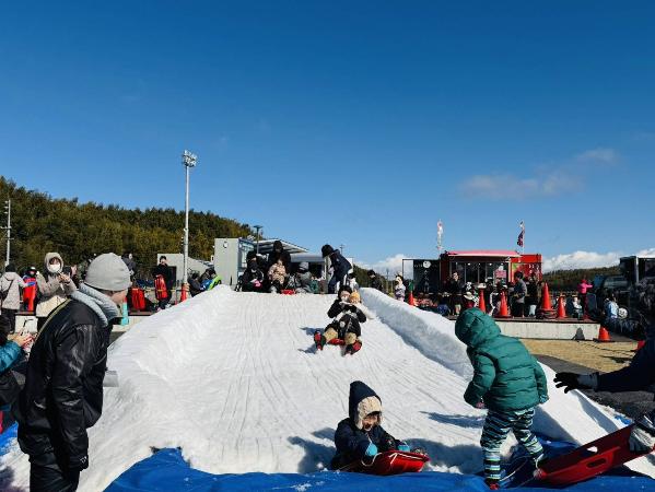 みはま雪フェスにおいて、雪の滑り台を子どもたちが滑っている様子